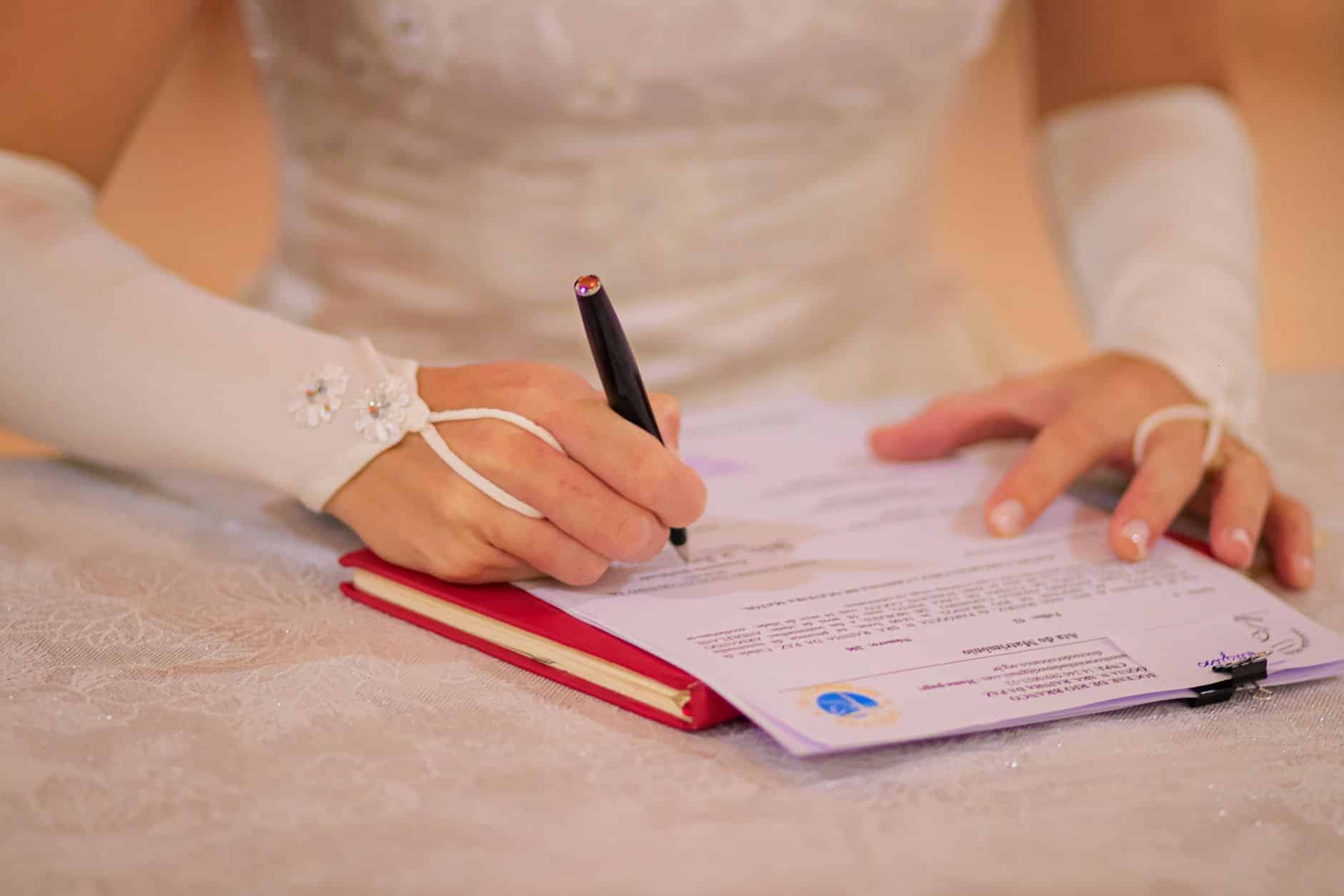 Couple signant un contrat de mariage avec clause d'attribution intégrale chez notaire